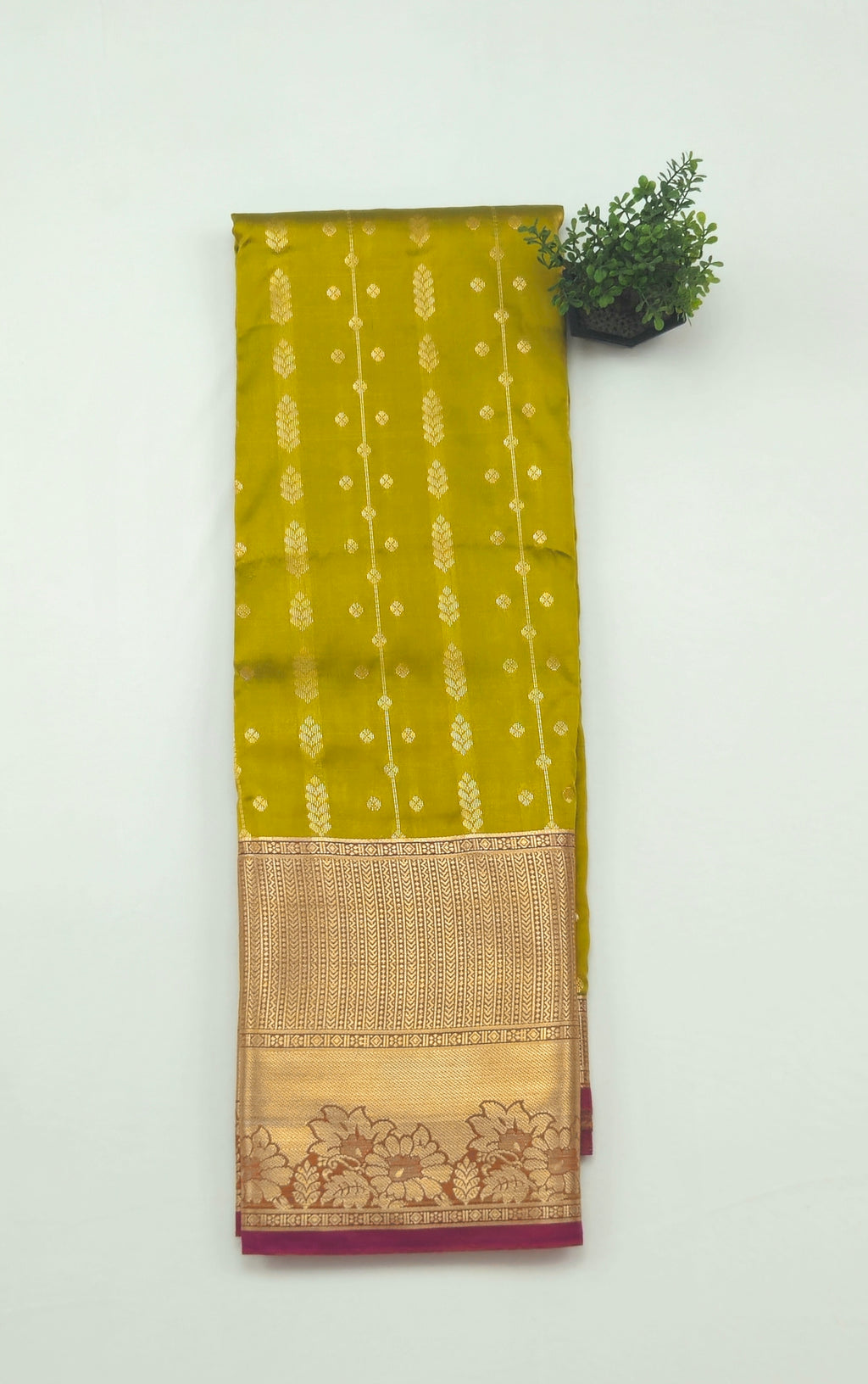 Kanchivaram golden line weaves saree in olive green color with geometric weaves