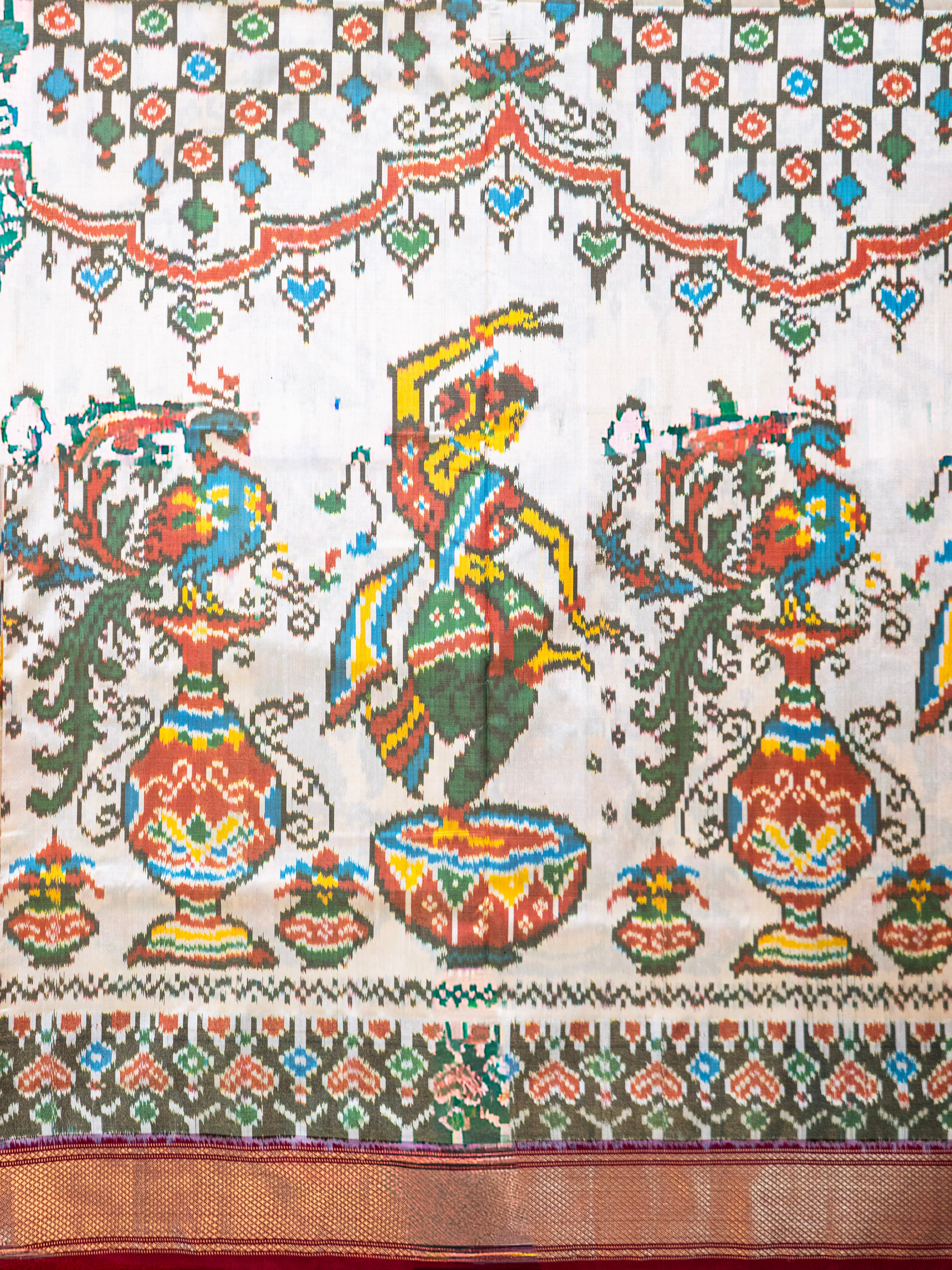 Pure Pochampally Double Ikat Silk Saree in White with Animal & Human Motifs and Red Pallu