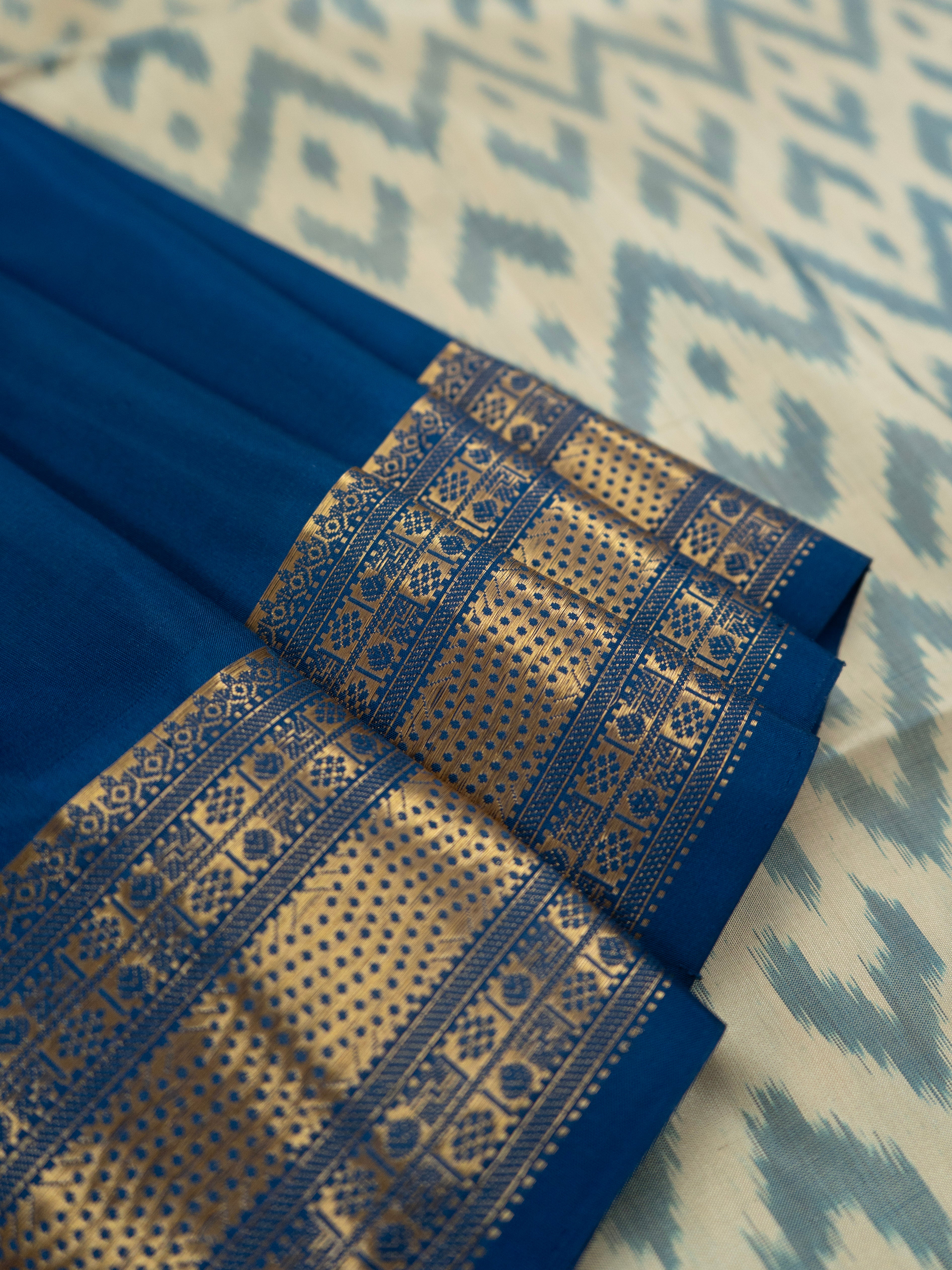 Pure Pochampally Double Ikat Silk Saree in White with Blue Ikat Pallu & Gold Zari Border