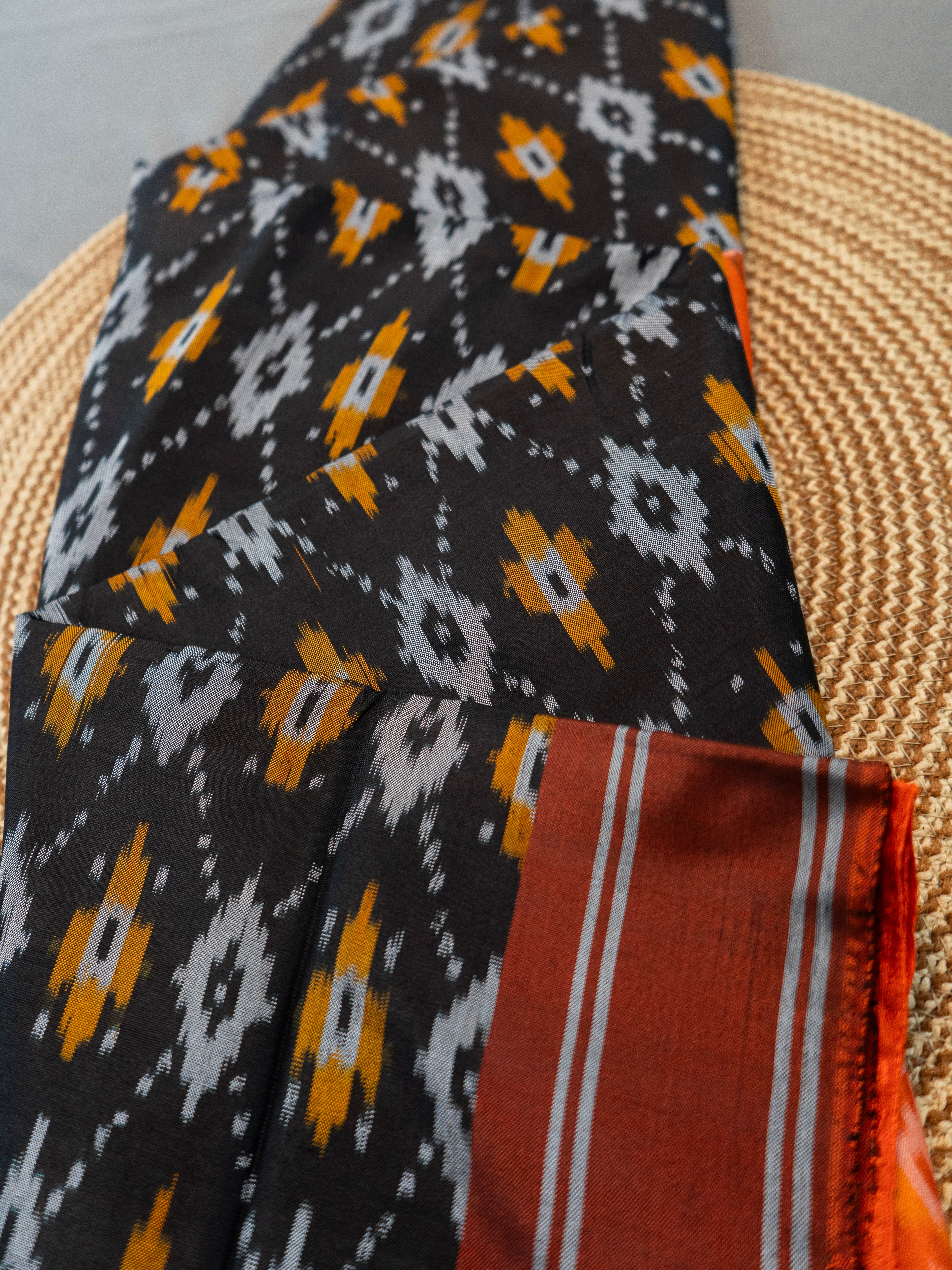 Pure Pochampally Silk Saree in Black with Orange Ikat Pallu & Border