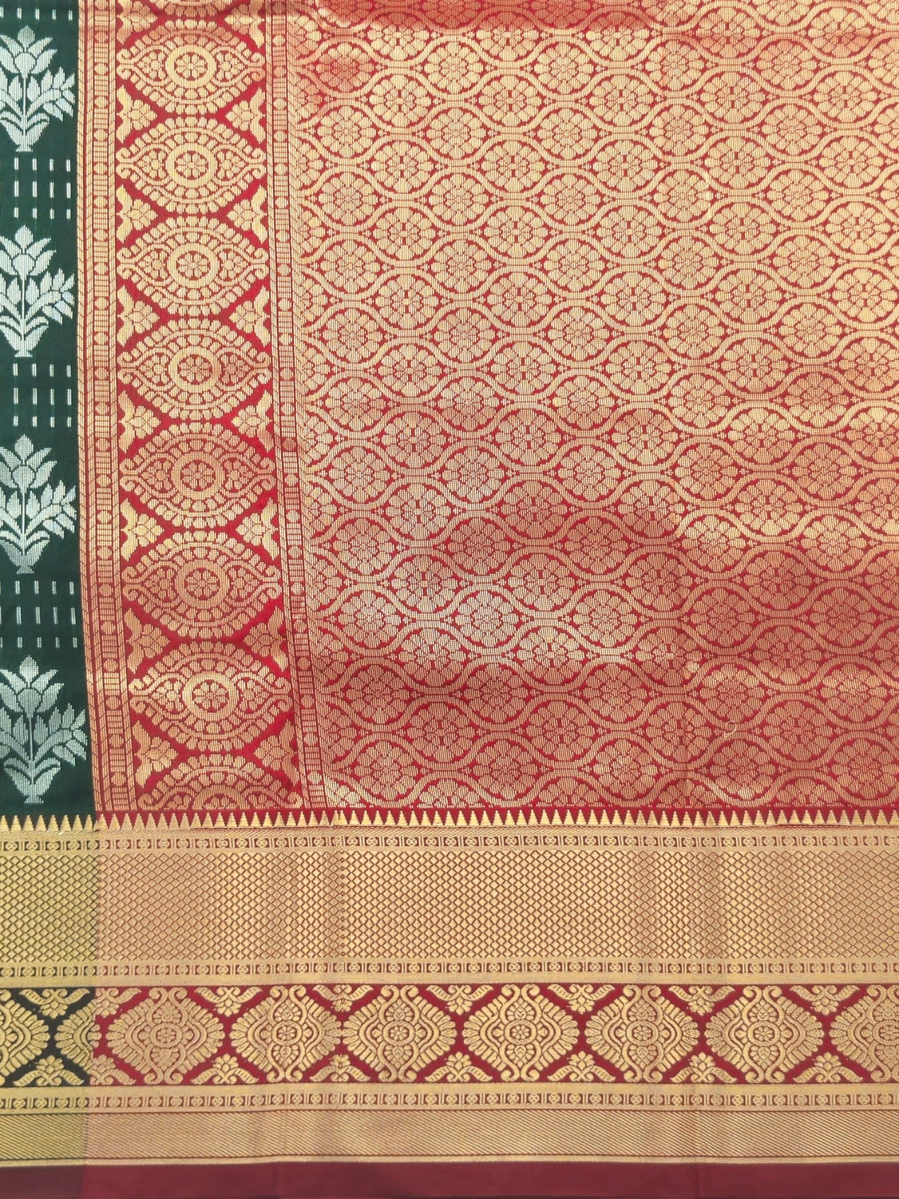 Kanchivaram silver weaving saree with gold pattu border in dark greencolor with contrast blouse