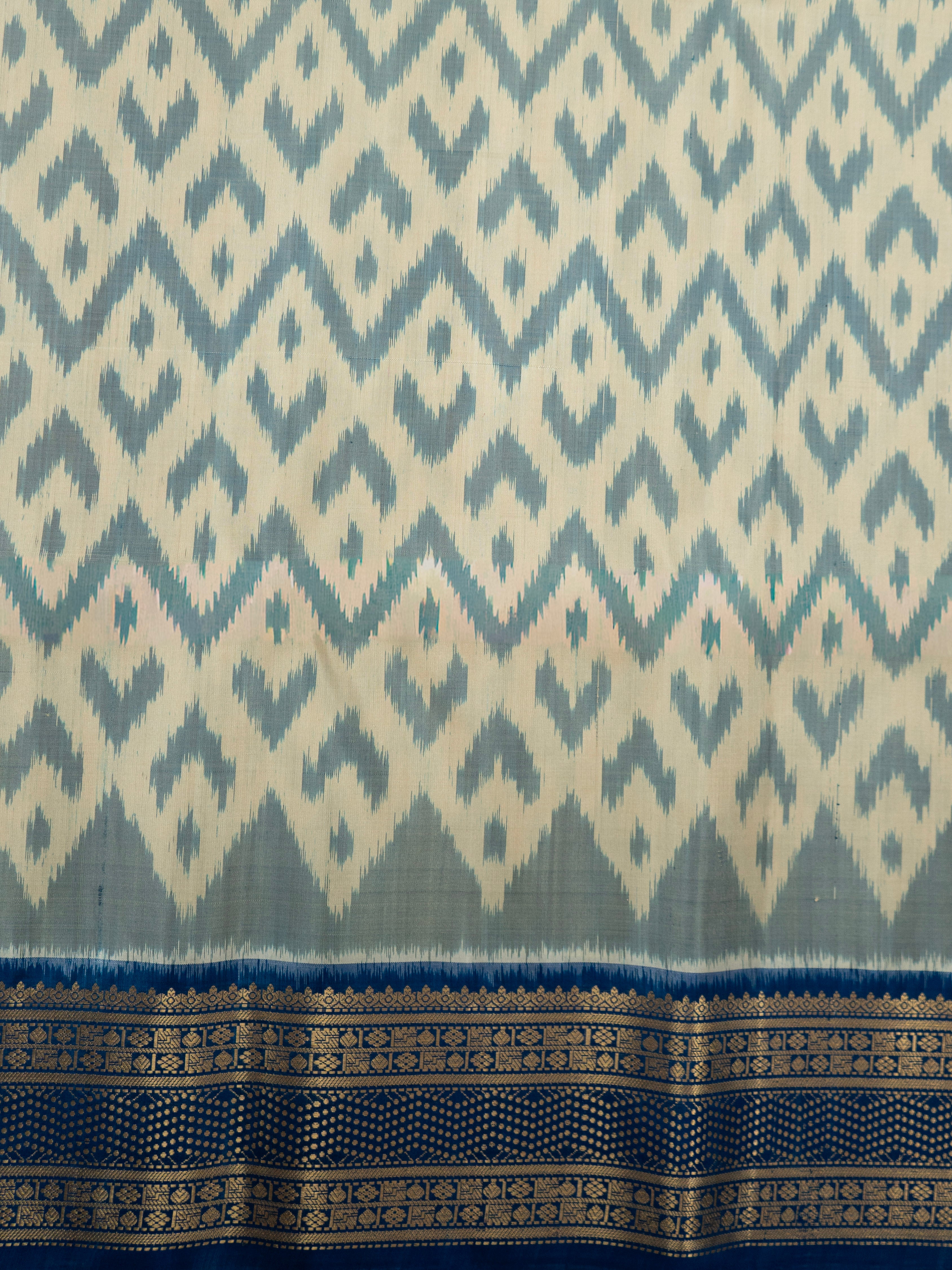 Pure Pochampally Double Ikat Silk Saree in White with Blue Ikat Pallu & Gold Zari Border