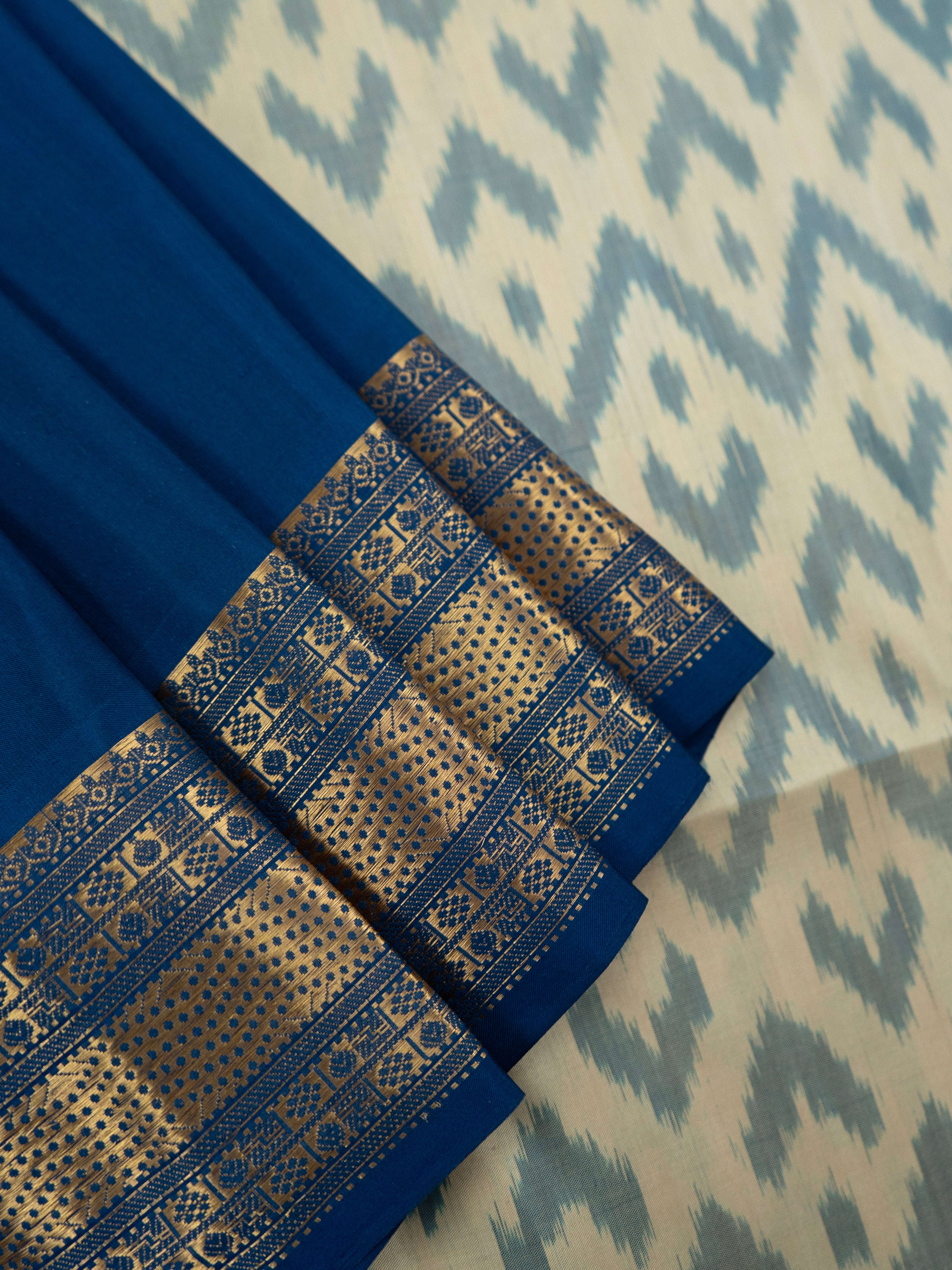Pure Pochampally Double Ikat Silk Saree in White with Blue Ikat Pallu & Gold Zari Border